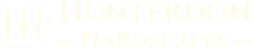 Clickable white logo from Hunterdon Hardscapes website that redirects to homepage.